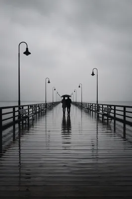 Kindness Under Umbrella on Rainy Pier