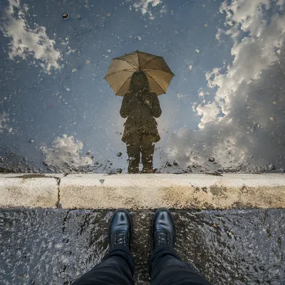 Umbrella Reflection in Rain Puddle Street