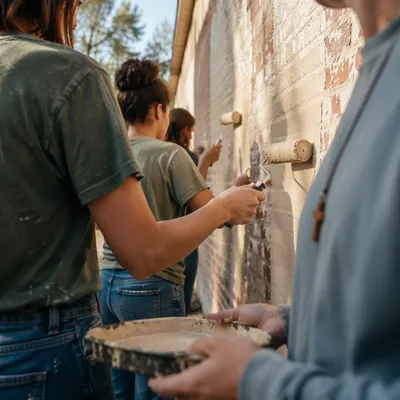 Faith Volunteers Painting Community Wall Together