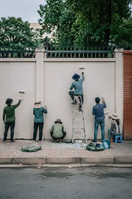 Community Volunteers Painting an Urban Wall