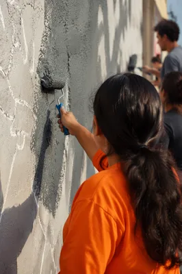 Community Volunteers Painting a Neighborhood Wall