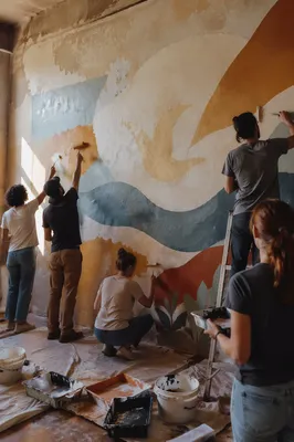 Community Volunteers Painting Hopeful Mural Together