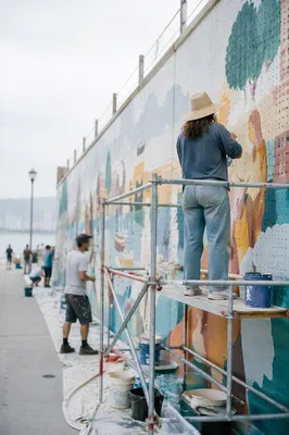 Community Volunteers Painting Waterfront Mural Together