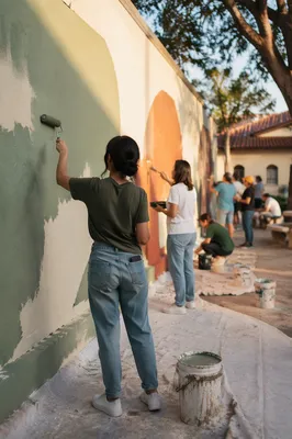 Volunteers Painting a Community Wall Together