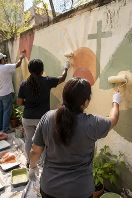 Church Volunteers Painting Community Garden Mural