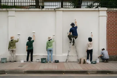 Community Volunteers Painting Urban Wall Together