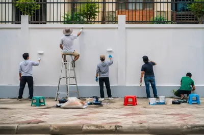 Community Volunteers Painting Neighborhood Wall Together