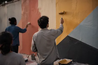 Community Volunteers Painting a Neighborhood Wall