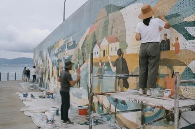 Community Volunteers Painting Waterfront Mural Together