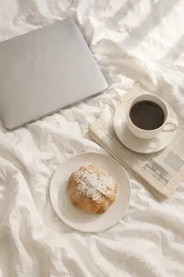 Relaxed Weekend Coffee and Newspaper in Bed