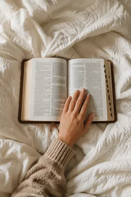 Open Bible on Cozy White Blanket