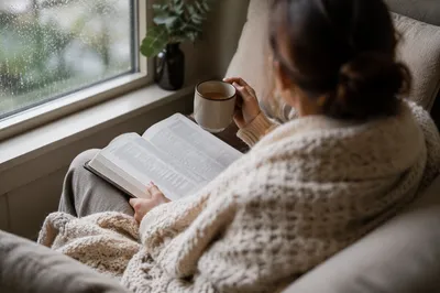 Woman Reading by Rainy Window