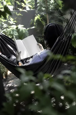 Woman Reading in Garden Hammock