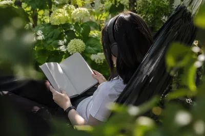 Woman Reading in a Garden Hammock