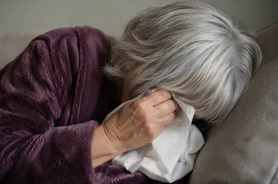 Older Woman Wiping Tears in Quiet Comfort