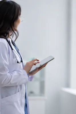 Doctor With Stethoscope Using Tablet