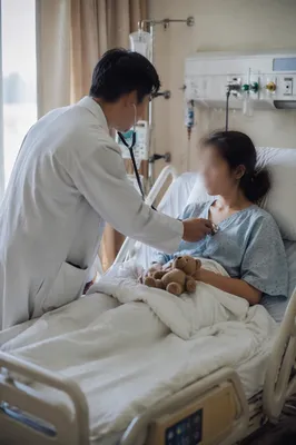 Compassionate Doctor Examining Patient in Hospital Room