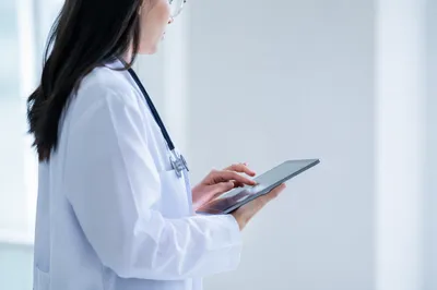 Doctor With Tablet in Modern Hospital