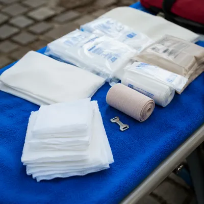 Emergency First Aid Supplies on Blue Blanket