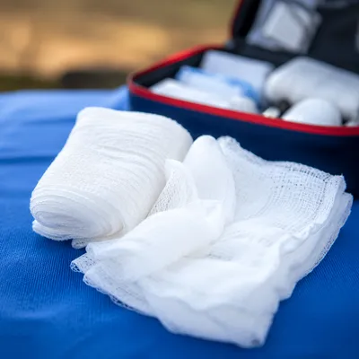 First Aid Gauze on Blue Medical Cloth