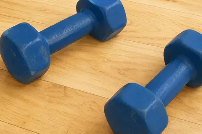 Blue Dumbbells on Maple Gym Floor