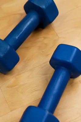 Blue Dumbbells on Maple Gym Floor