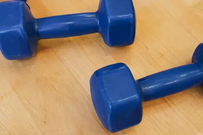 Blue Dumbbells on Wood Rehab Floor