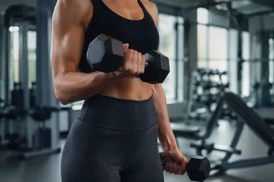 Focused Dumbbell Curl in Modern Gym