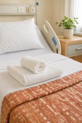 Clean Hospital Bed with Folded Towels