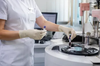 Medical Lab Technician Handling Blood Test Tubes