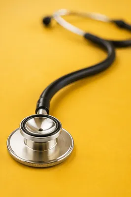 Close-Up Stethoscope on Mustard Yellow Surface