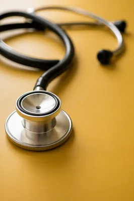 Close Up Stethoscope on Mustard Surface