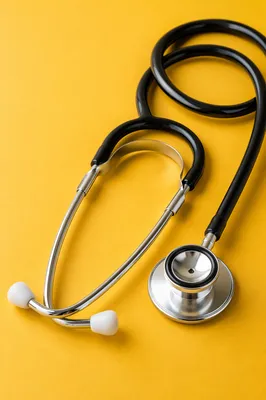 Close Up Stethoscope on Mustard Surface