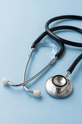 Close Up Stethoscope on Pastel Blue Surface