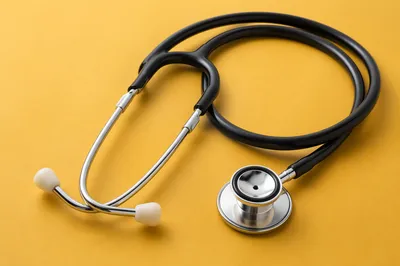 Close Up Stethoscope on Mustard Surface