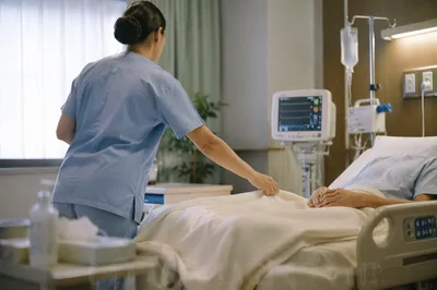 Nurse Caring for Patient in Hospital Room