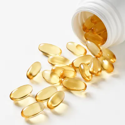 Golden Softgel Capsules on Clean Pharmacy Surface