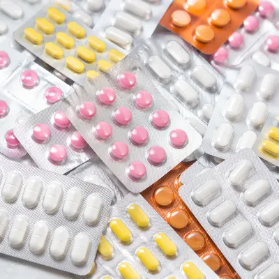 Assorted Medicine Blister Packs on Pharmacy Counter