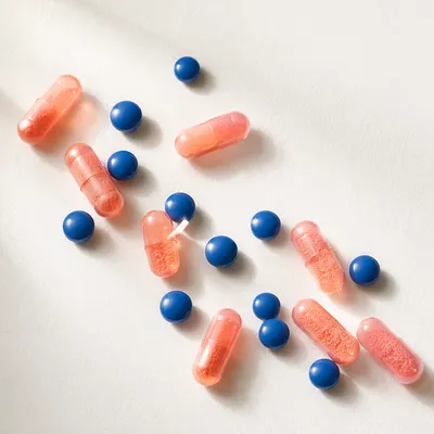 Assorted Capsules and Blue Tablets Flat Lay