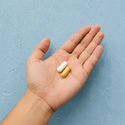 Medicine Capsules Resting in Open Palm