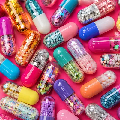 Colorful Capsules on Vivid Pink Surface