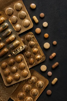 Bronze Pharmacy Pills on Charcoal Background