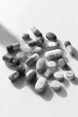 Monochrome Medicine Capsules on White Surface