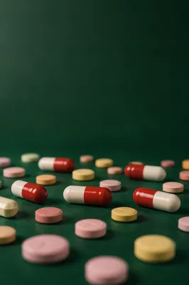 Medicine Capsules on Deep Green Background