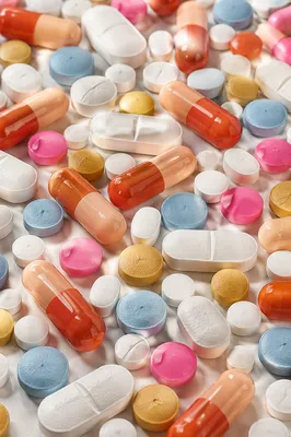 Colorful Pills on White Pharmacy Counter