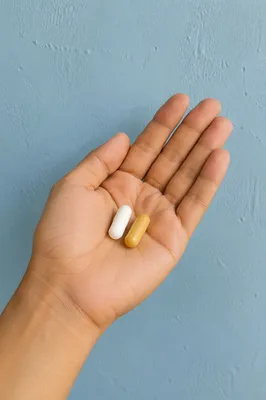 Medicine Capsules Resting in Open Palm