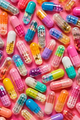 Colorful Capsules on Vivid Pink Surface