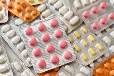 Assorted Medicine Blister Packs on Pharmacy Counter
