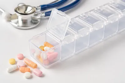 Weekly Pill Organizer with Spilled Medicine