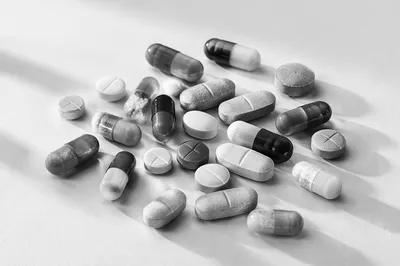 Monochrome Medicine Capsules on White Surface